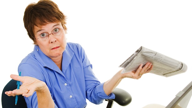 confused lady with newspaper