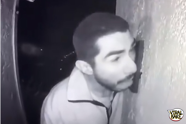 man licking doorbell