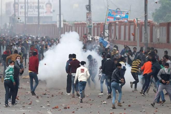police fires tear gas as migrant workers pelt stones at them in surat - viral bake