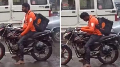 Swiggy Delivery Agent Waiting Without Raincoat For A Green Signal