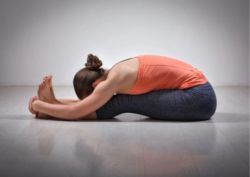 8 Calming Yoga Poses to Help you Relieve Stress in Winter: Sitting Forward Bend Yoga Pose