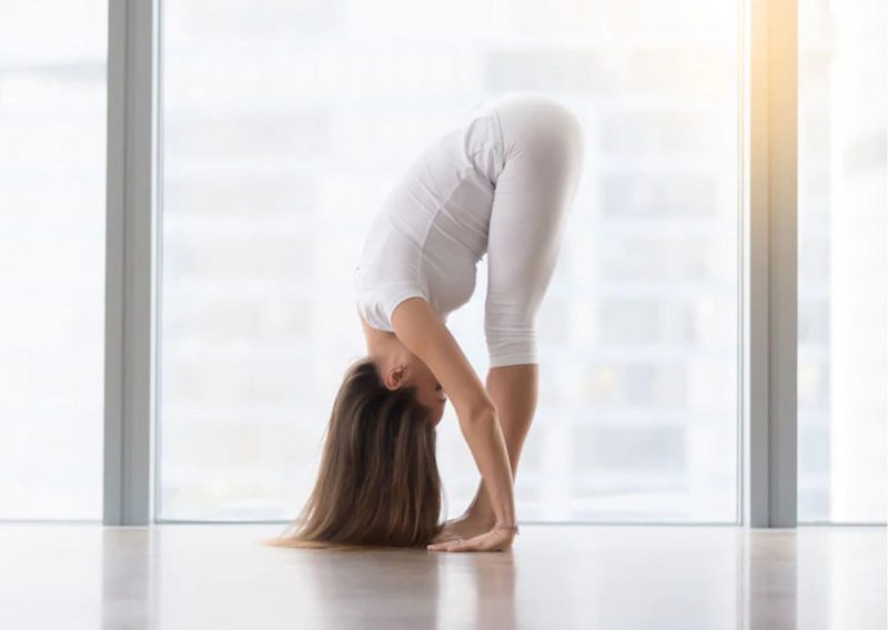 8 Calming Yoga Poses to Help you Relieve Stress in Winter: Standing Forward Bend Yoga Pose